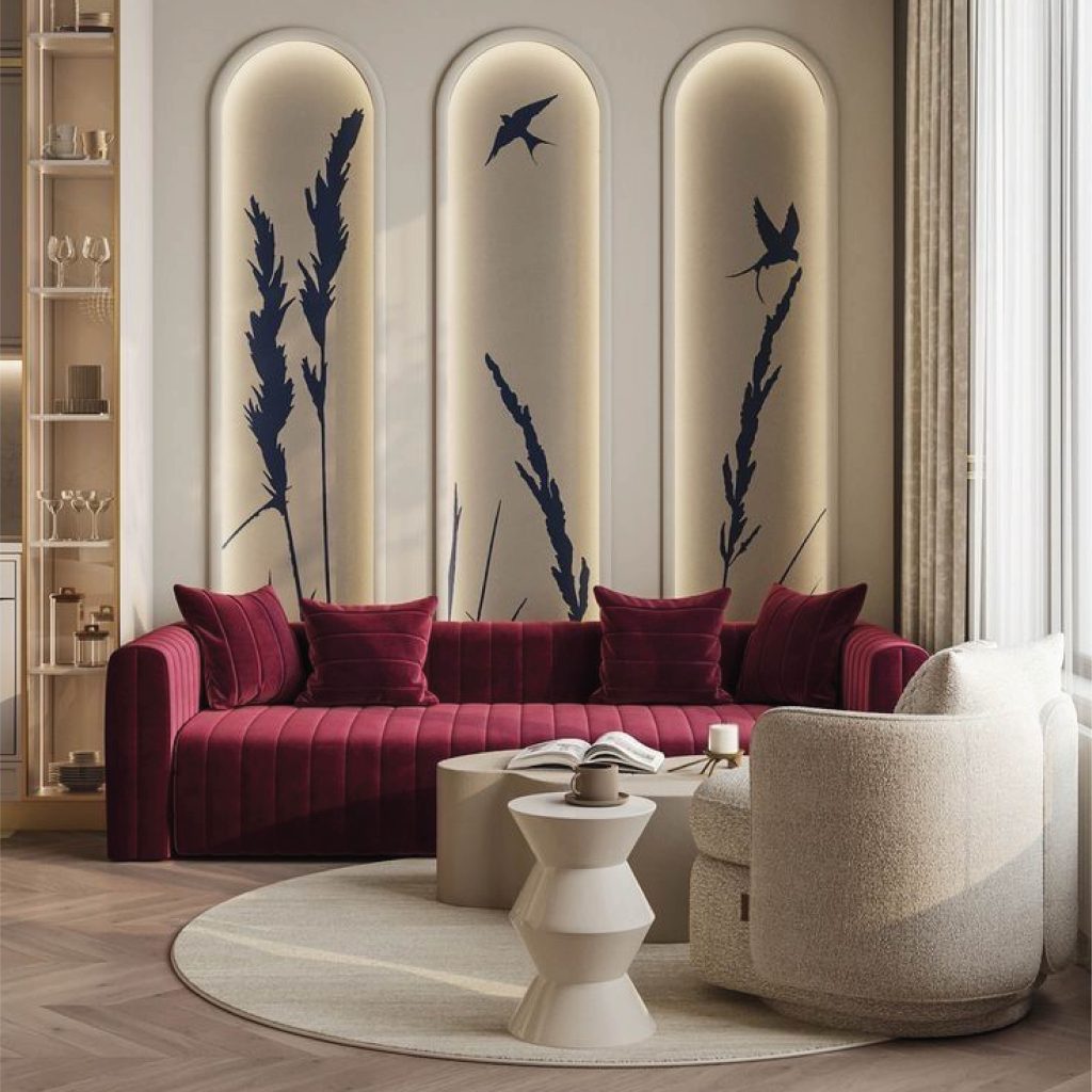 The focal point is the wall behind the sofa, designed with three tall arched niches. Each niche has warm backlighting and minimalist artwork featuring delicate plants and birds, giving it an artistic, almost gallery-like feel.